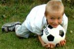 Young Boy Hugging Soccer Ball